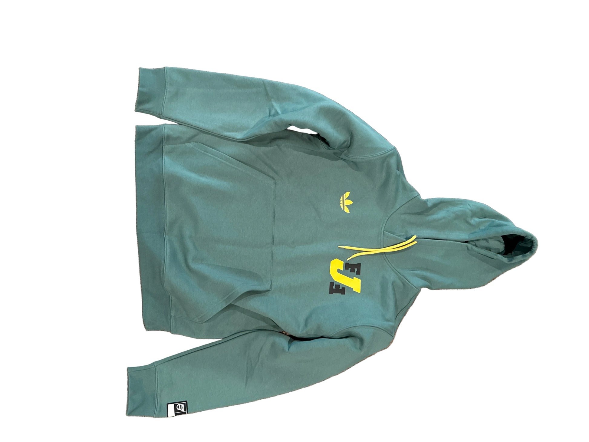 Green hoodie with yellow drawstrings on a beige 